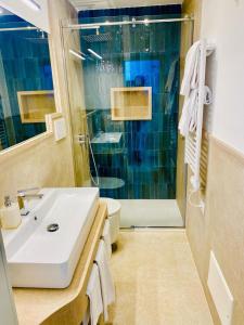 a bathroom with a sink and a shower at Rooftop luxury apartment in Capri