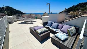 a patio with couches and a table on a balcony at Rooftop luxury apartment in Capri