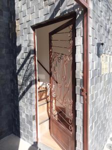 a wooden door in a brick wall with a brick wall at Bem Estar no Bom Ap 2 in Arapiraca