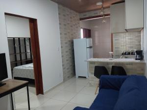 a kitchen with a refrigerator and a table and chairs at Bem Estar no Bom Ap 2 in Arapiraca