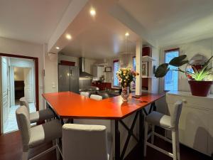a kitchen with a wooden table and chairs at Red Flat Paris in Paris