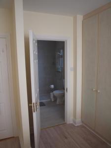 an empty bathroom with a toilet and a doorway at Chez Sé in Drogheda +10 photos