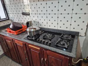 a kitchen stove with a pot on top of it at G and E Guesthouse in Kumba