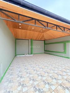a large empty room with a wooden ceiling at Novxanı Villa in Baku
