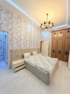 a bedroom with a bed and a chandelier at Novxanı Villa in Baku +16 photos