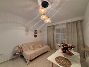 a living room with a couch and a table at Apartamentos Amy 3 con vista a mar in Palos de la Frontera