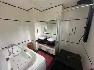 a bathroom with two sinks and a shower at Garden-level studio in Hautot-sur-Mer