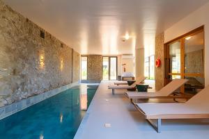 a pool with chaise lounge chairs and a swimming pool at 2-suite apartment just a few meters from Rua Coberta. in Gramado