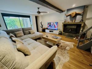 a living room with a couch and a fireplace at Maison La Réclusière 4 étoiles - Piscine in Vienne