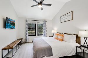 a bedroom with a bed and a ceiling fan at Woodacre Cottage in Wimberley