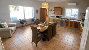 a kitchen and living room with a table and chairs at Can Catalina in Can Furnet