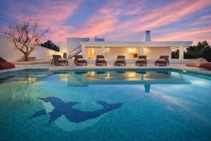 a swimming pool in front of a house at Can Catalina in Can Furnet