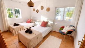 a living room with two beds and a couch at Can Catalina in Can Furnet +15 photos