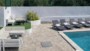 a patio with lounge chairs and a swimming pool at Can Catalina in Can Furnet
