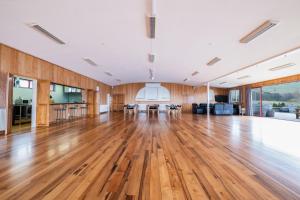 an empty room with a wooden floor and wooden walls at Omori Lodge in Tokaanu +24 photos