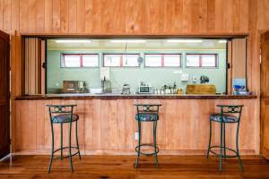 a kitchen with two stools at a bar at Omori Lodge in Tokaanu