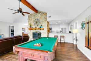 a living room with a pool table at Arrowhead Falls in Wimberley