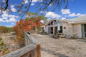 a house with a wooden fence and a wooden walkway at Arrowhead Falls in Wimberley