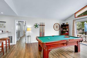 a living room with a pool table in it at Arrowhead Falls in Wimberley +24 photos