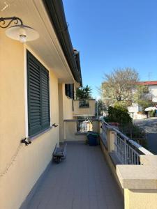 a balcony with a bench on the side of a building at Mary's House in Guardistallo