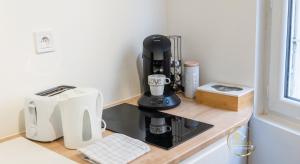 a coffee maker on a counter in a kitchen at Escapade studio centre ville Rodez in Rodez
