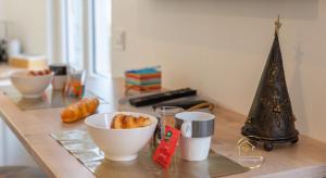 a table with a bowl of bread and a christmas tree at Escapade studio centre ville Rodez in Rodez
