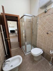 a bathroom with a shower and a toilet and a sink at Mary's House in Guardistallo