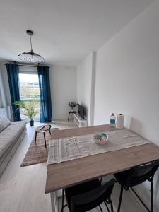 a living room with a table and a couch at Studio cosy - Proche centre Dijon in Dijon