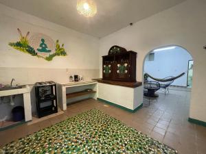 a room with a kitchen with a sink and a table at Casa Malinalli in Zihuatanejo +14 photos