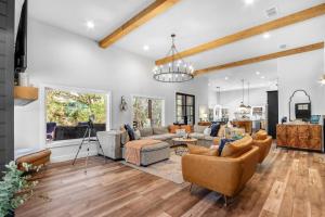 a living room with a couch and chairs at Barndo on the Blanco in Wimberley