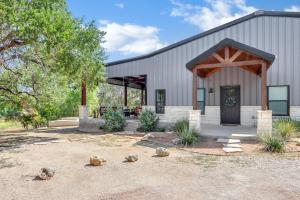 a house with a barn with rocks in front of it at Barndo on the Blanco in Wimberley