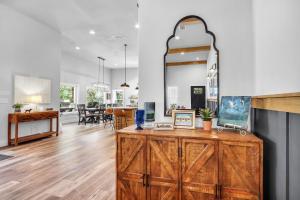 a kitchen and living room with a wooden dresser at Barndo on the Blanco in Wimberley +46 photos