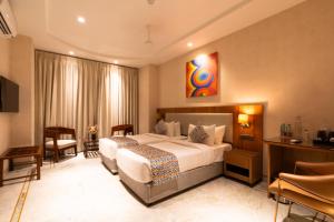 a hotel room with a large bed in a room at Hotel Bluestone Prime Nehru Place by The Cosy hotels in New Delhi