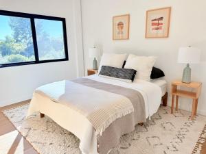 a white bedroom with a bed and a window at Private Hillside 2BR Suite Near Town in Ojai