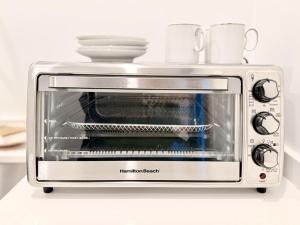 a toaster oven with two cups on top of it at Private Hillside 2BR Suite Near Town in Ojai
