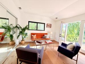 a living room with an orange couch and chairs at Private Hillside 2BR Suite Near Town in Ojai
