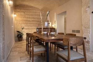 a dining room with a wooden table and chairs at CAVA Urban Relais & Pool in Lecce
