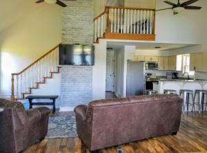 a living room with two couches and a kitchen at Potter Cottage - Beautiful Serene Setting in Ferdinand