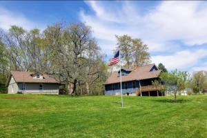 a house with an american flag in the yard at Potter Cottage - Beautiful Serene Setting in Ferdinand