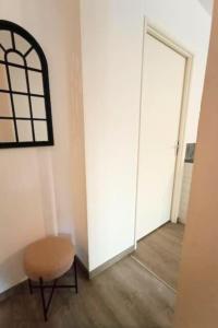an empty room with a chair and a door at Le Grand RepublicainT2 in Le Péage-de-Roussillon