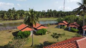 a view of a resort with a lake and palm trees at windy beach kite resort in Kalpitiya