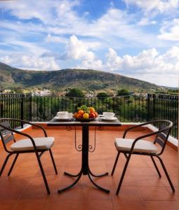 a table with a bowl of fruit on a balcony at Rodanthy Studios IV in Katelios +4 photos