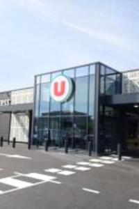 a large glass building with a sign on it at Le Grand RepublicainT2 in Le Péage-de-Roussillon