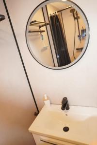 a bathroom with a mirror over a sink at Next To Sea in Vlissingen +8 photos