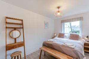 a bedroom with a bed and a ladder and a window at 2 Bed in Woolacombe oc-bsnug in Woolacombe