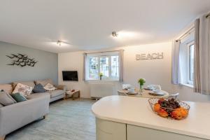 a living room with a couch and a table at 2 Bed in Woolacombe oc-bsnug in Woolacombe
