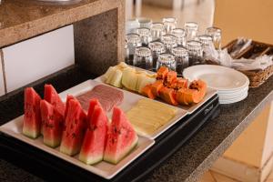 a tray of different types of food on a counter at Mais Hotel in Araguaína