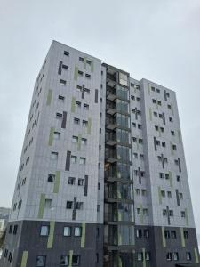 a tall gray building with many windows at Snow Sky in Passo del Tonale