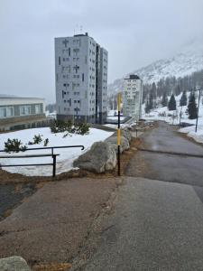 an empty street with snow on the ground and buildings at Snow Sky in Passo del Tonale