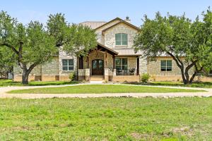 a house with trees in front of it at Big Red Chicken Estate in Wimberley